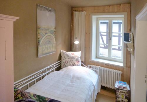 a bedroom with a bed and a window at Ferienhaus Marktstraße in Tangermünde