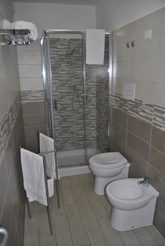 a bathroom with a shower and a toilet and a sink at B&B dal Gallo in Battipaglia