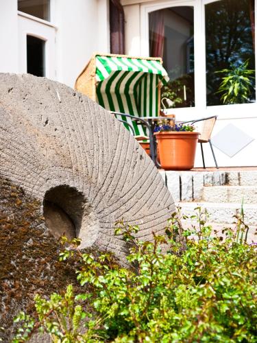 a table and a chair on a patio at Flair Landhotel Strengliner Mühle in Pronstorf