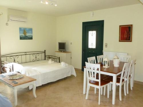A bed or beds in a room at Ktima Pyroessa Apartments - Blue Apartment