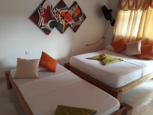 Una cama o camas en una habitación de Hostel Cattleya