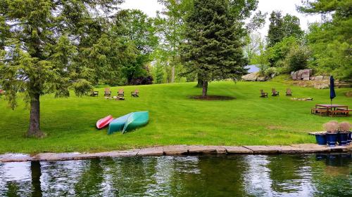 a park with a lake with boats on the grass at The Ledges Resort & Marina in Alexandria Bay