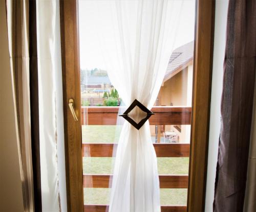 a wedding dress hanging in front of a window at Penzion Na Americe in Nové Jirny