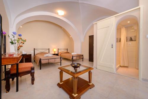 a living room with two beds and a table at Mantilaria in Fira