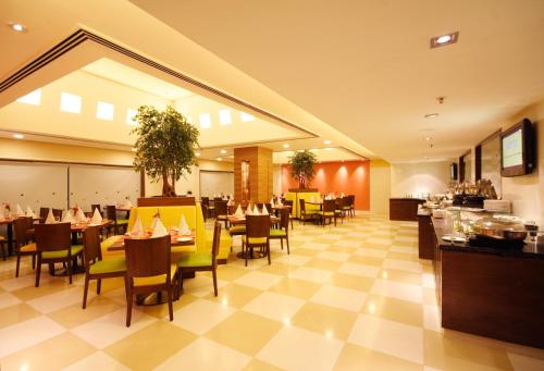 A restaurant or other place to eat at Aditya Hometel