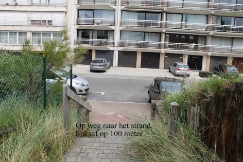 a sign in front of a building with a parking lot at Prinses Elisabeth in Koksijde