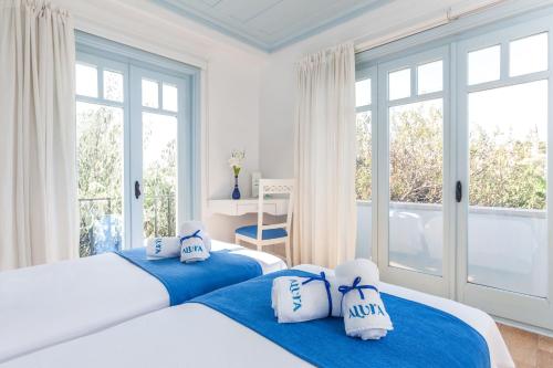 מיטה או מיטות בחדר ב-Alura Hotel