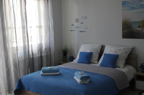 a bedroom with two beds with towels on the bed at Maritime Apartment in Świnoujście