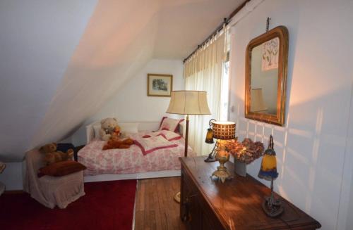 a bedroom with a bed with teddy bears on it at Villa Vero in Contrexéville