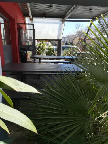 a bench sitting on a porch next to a plant at hotelF1 Avignon Centre Courtine gare TGV in Avignon
