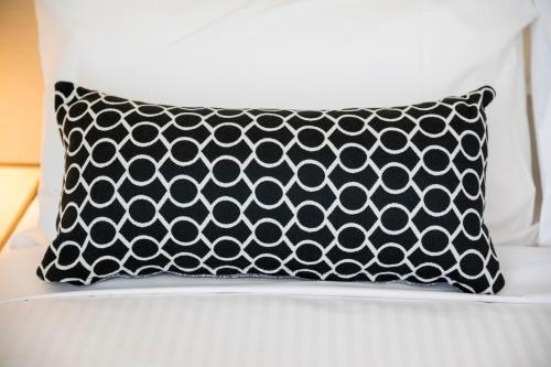 a black and white pillow sitting on a bed at Nightcap at Finsbury Hotel in Adelaide