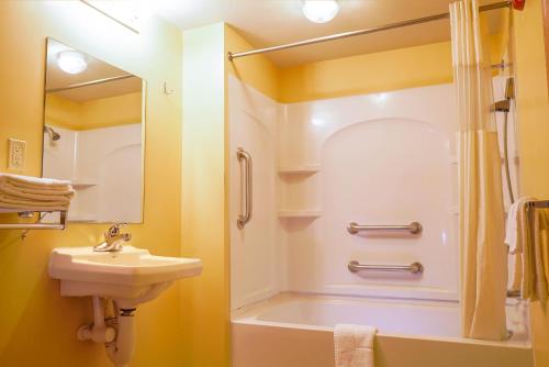 a bathroom with a sink and a shower at Regal Inn Coffeyville in Coffeyville