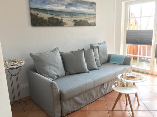 a couch in a living room with a painting on the wall at Haus Hugo in Zingst