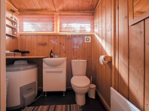 a small bathroom with a toilet and a sink at Lovely Cabin in the Capital Area with hot tube in Hafnarfjördur
