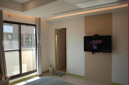 Blowing in the wind Homestayにあるテレビまたはエンターテインメントセンター