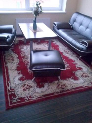 a living room with a table and a couch at Marijonu Apartments in Panevėžys