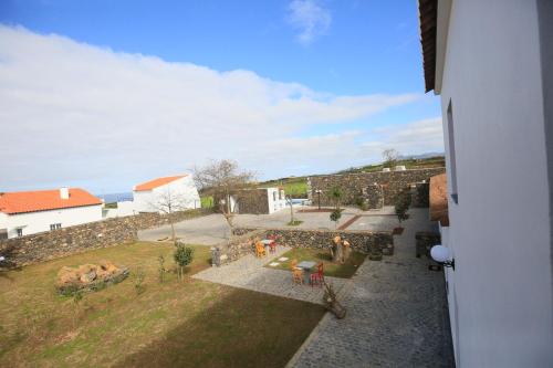 an aerial view of a garden with a stone wall at Quinta das Giestas in Ribeira Grande