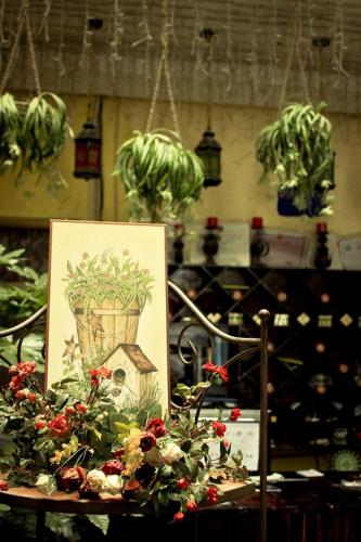 a table with a picture and flowers on it at Gaisang Mêdog Aroma Fragrance Hotel in Lhasa