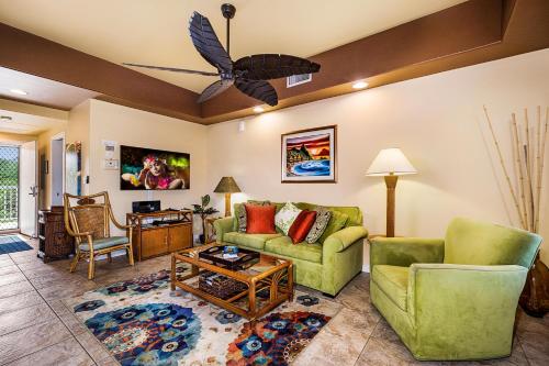 a living room with two couches and a table at Beach Villas Kahaluu on Kona Coast in Kailua-Kona