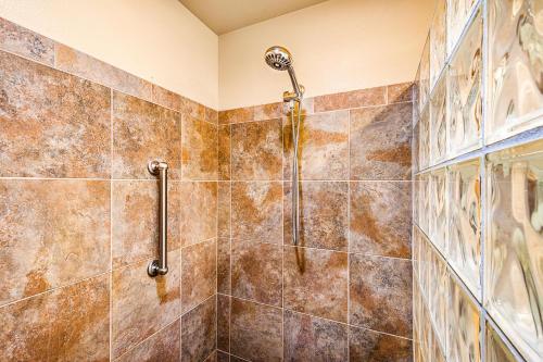a bathroom with a shower with brown tiles at Beach Villas Kahaluu on Kona Coast in Kailua-Kona
