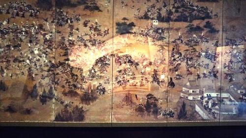 a painting of a crowd of people on a wall at Akakura Hotel in Myoko