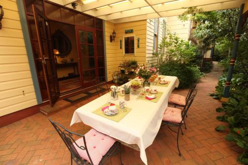 a table and chairs on a patio at Mountain Whispers Varenna Luxury in Leura