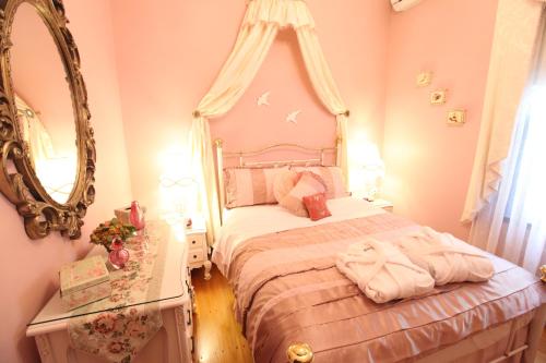 a pink bedroom with a bed and a mirror at Mountain Whispers Varenna Luxury in Leura
