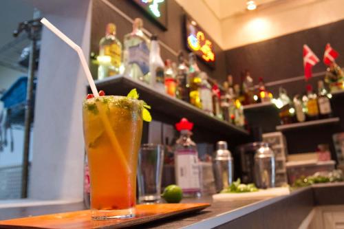 a drink sitting on top of a bar at The Oriental Tropical Beach at VIP Resort in Ban Phe