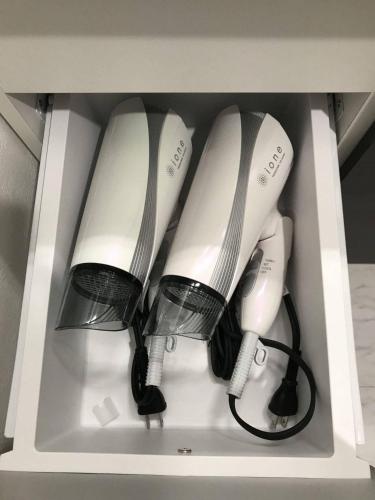 four white wii controllers in a white drawer at Seaside Villa Itoman in Itoman