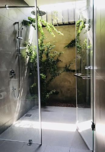 a bathroom with a shower with a painting on the wall at Kethaka Aga in Tissamaharama