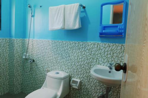 a bathroom with a toilet and a sink at Michelina Princess Guest House in Loboc