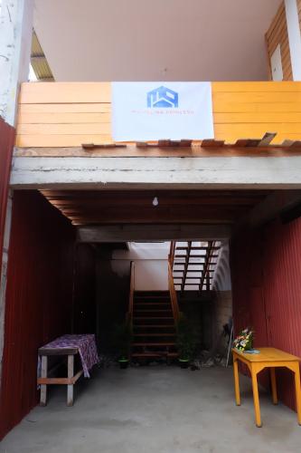 a building with a sign on top of it at Michelina Princess Guest House in Loboc