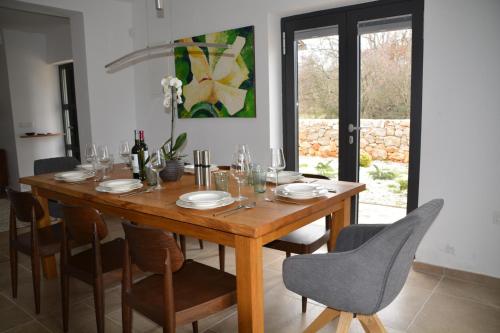 a wooden table with chairs and a dining room at Villa Kvarner in Krk