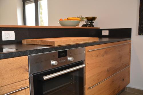 a kitchen with a stove and a bowl of oranges at Villa Kvarner in Krk