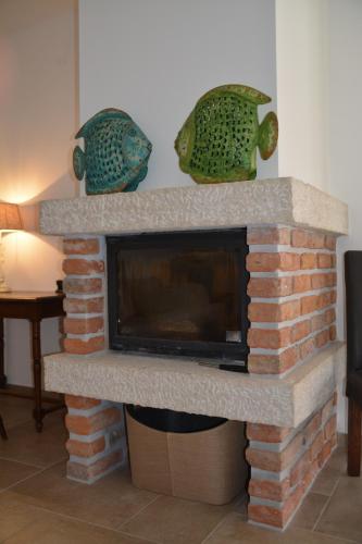 a brick fireplace with a tv on top of it at Villa Kvarner in Krk