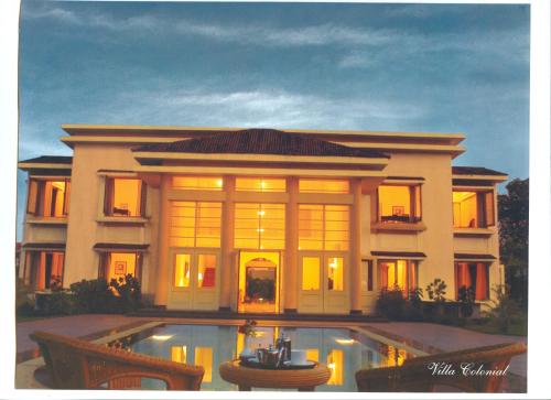 a large house with a pool in front of it at The LaLiT Golf & Spa Resort Goa in Canacona