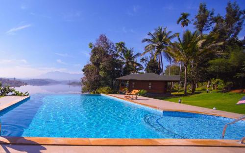 a swimming pool with a view of the water at LakeRose Wayanad Resort in Ambalavayal