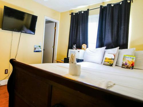 a bedroom with a bed with a television on the wall at Airport Lay Over in Denver