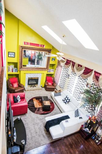 a living room with yellow walls and white furniture at Airport Lay Over in Denver