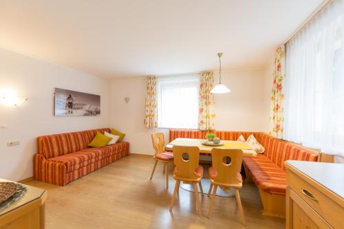 a living room with a couch and a table at Haus Schöpf in Kappl