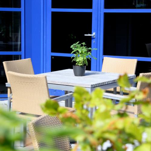 a table and chairs with a potted plant on it at Best Western Hotel Hillerød in Hillerød