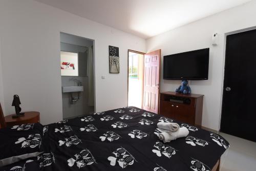 a bedroom with a bed with a doll laying on it at Flintstone Guest House בית ההארחה בן 11 החדרים אינו וילה פרטית אתם מזמינים רק חדרים לא את כל הוילה in Eilat