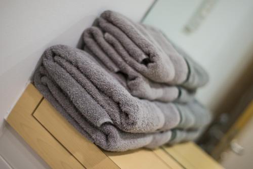 a pile of towels sitting on top of a table at ApexlivingNE - Luxury Balcony Apartment, Double Bed, WIFI in Sunderland