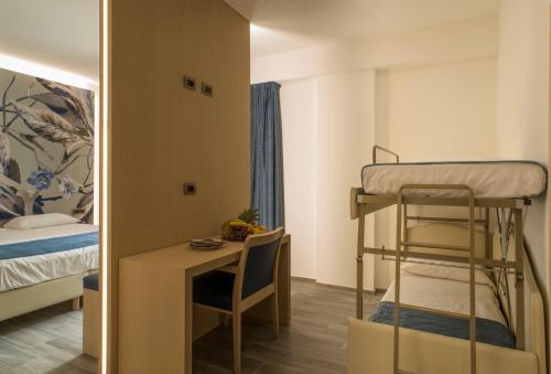 a small room with a bunk bed and a desk at Hotel Terme Capasso in Contursi