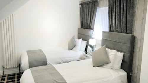 a hotel room with two beds and a window at Number 4 in Derry Londonderry