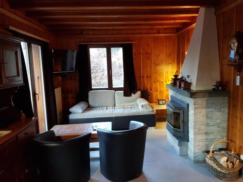 a living room with a couch and a fireplace at Chalet Amanda in Champéry