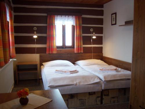 a bedroom with two beds and a window at Pension Skalicky in Pec pod Sněžkou