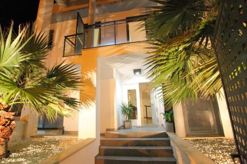 a building with palm trees in front of it at Can Pastilla II in Can Pastilla