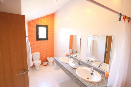 a bathroom with two sinks and a toilet at Can Pastilla II in Can Pastilla