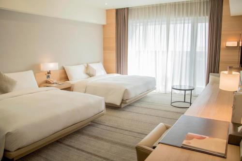 Postel nebo postele na pokoji v ubytování Hotel COZZI Ximen Tainan